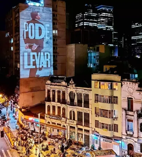 Projeção "Pode levar" em empena de edifício no centro do Rio de Janeiro